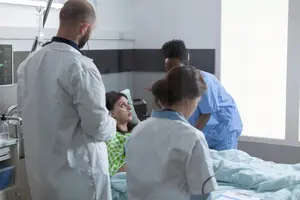 A patient surrounded by medical professionals.