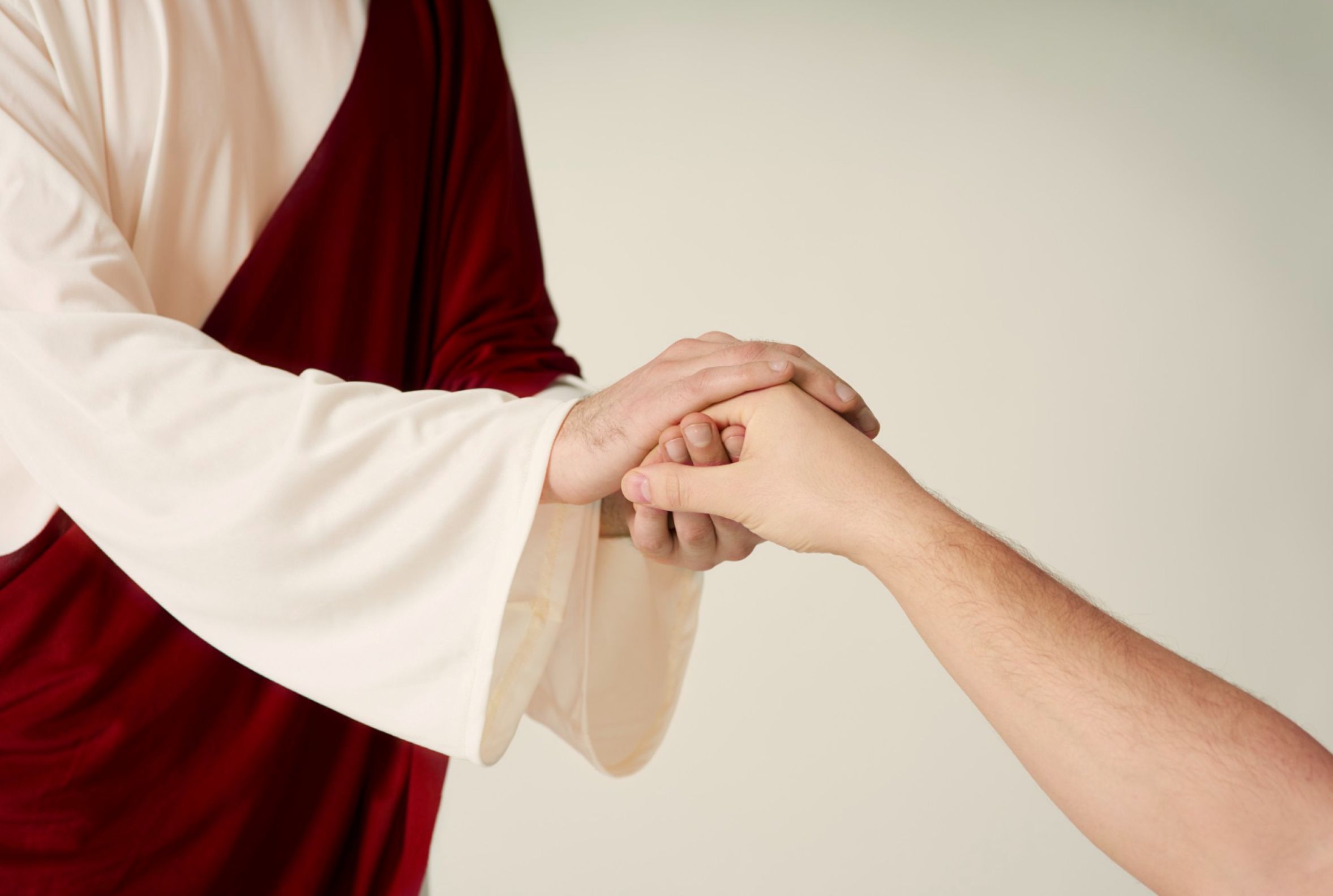 Jesus holding the hand of a believer tightly. Jesus holding the hand of a believer tightly.