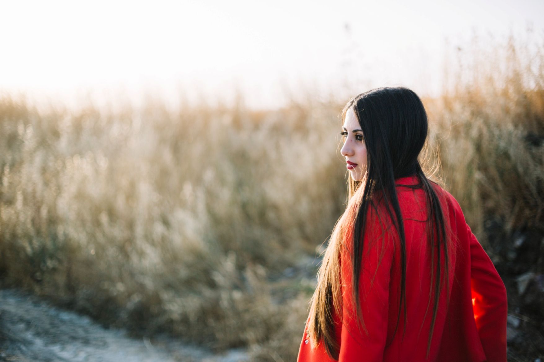 A woman in a field of long grass. A woman in a field of long grass.