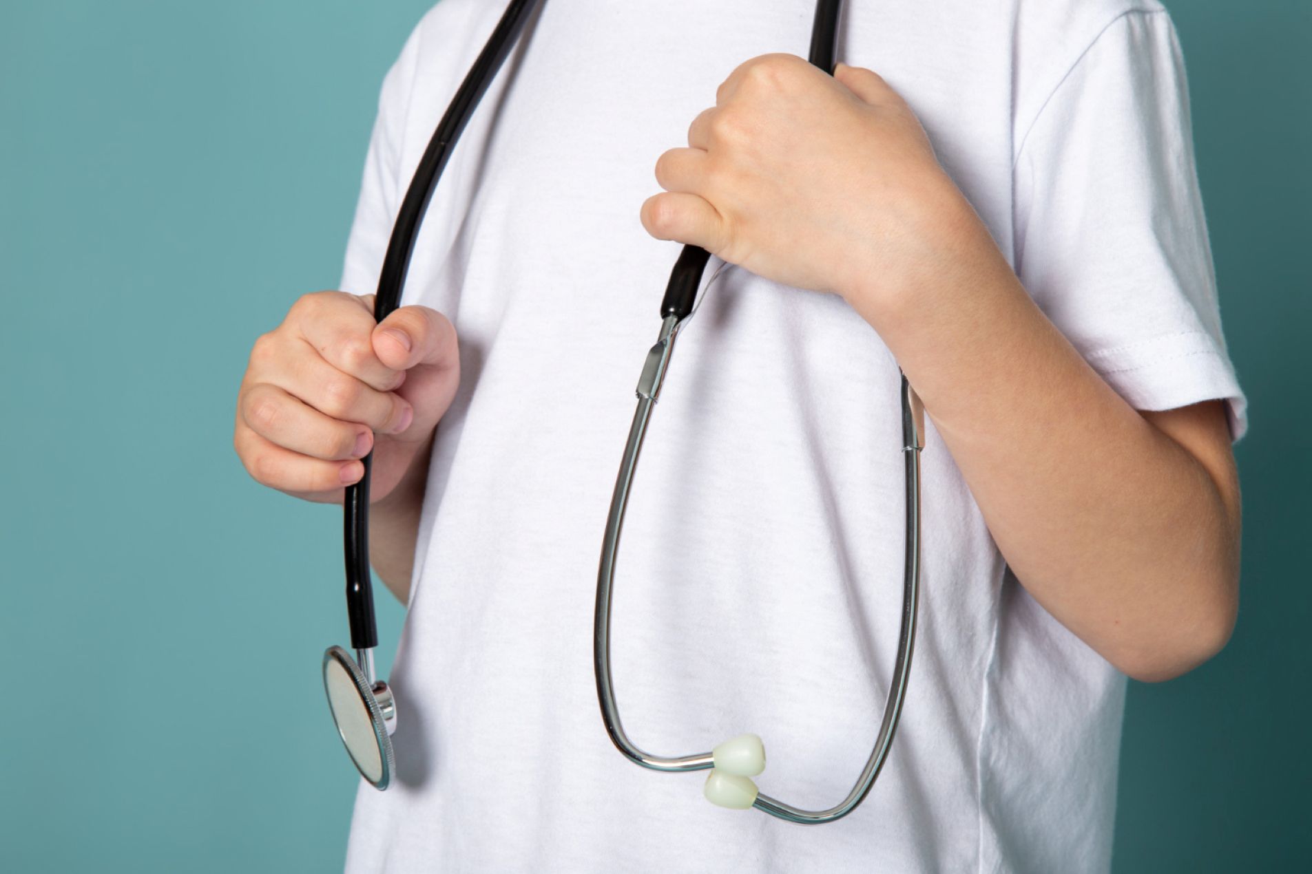A child wearing a stethoscope.