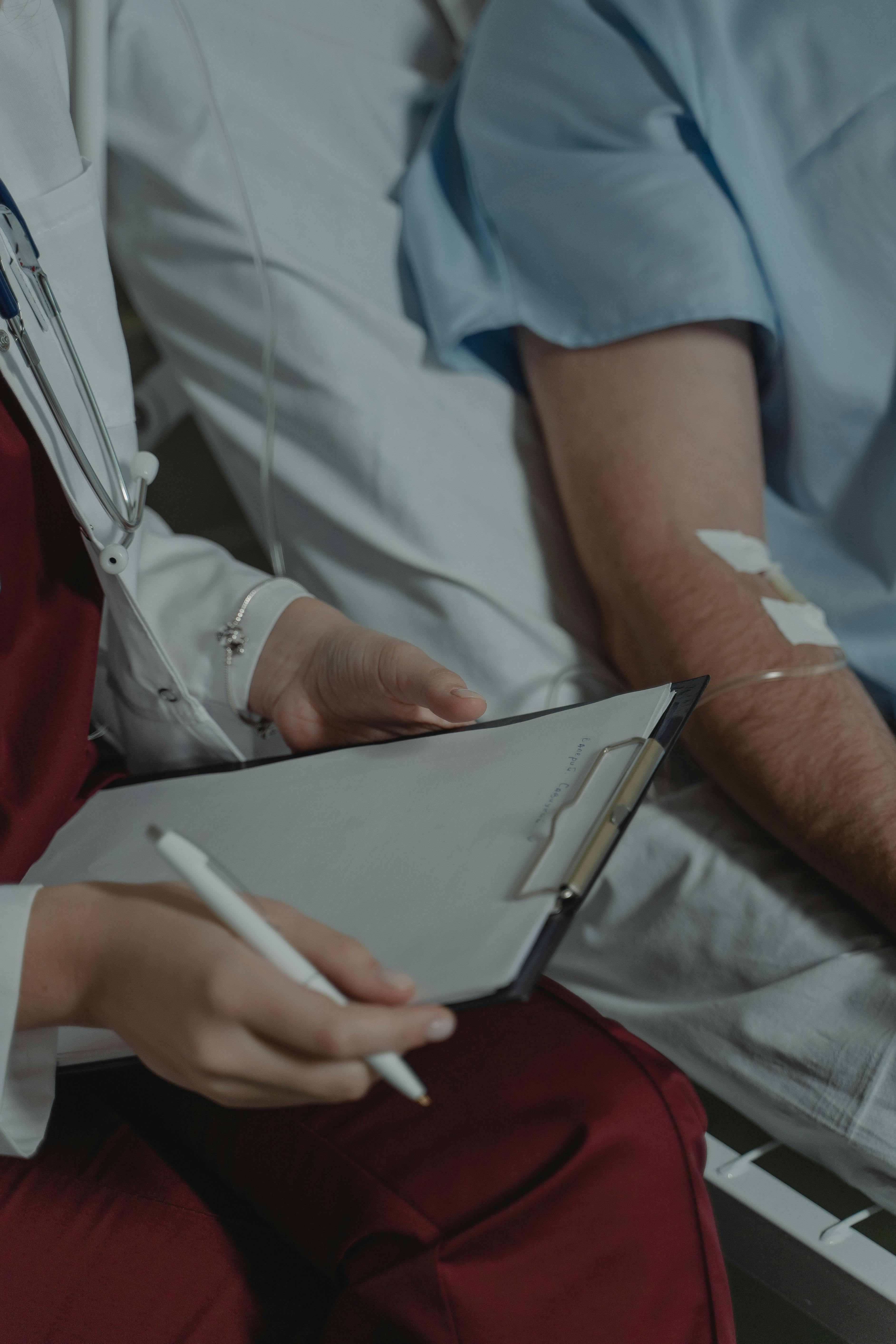doctor talking with patient in hospital room